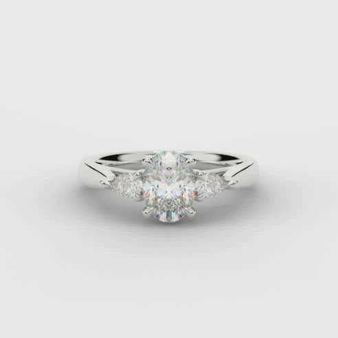 Oval and Pear Shape Three Stone Diamond Ring in Platinum